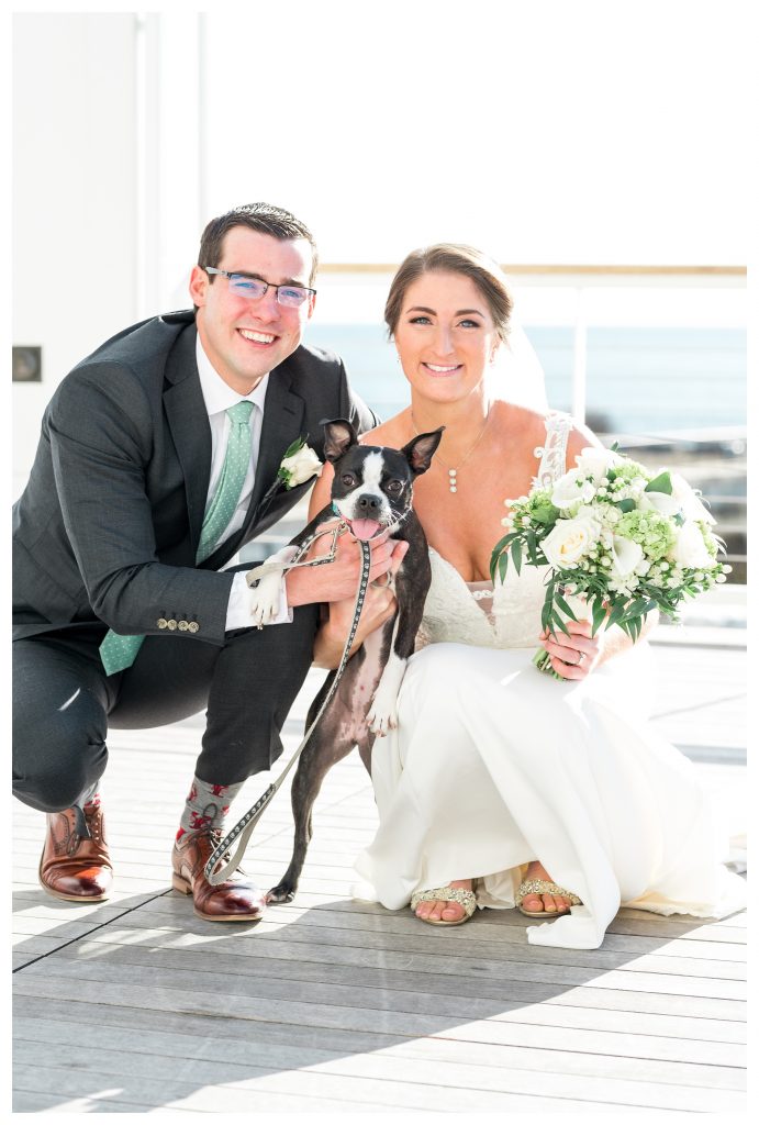 Newlyweds posing with dog during Beauport Hotel wedding celebration