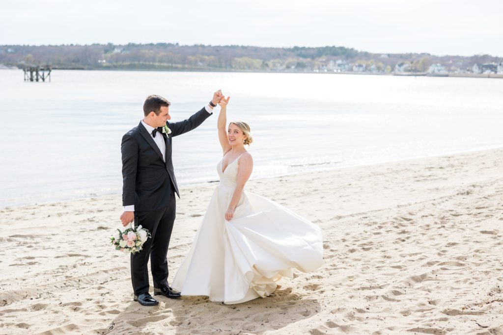 Bride and groom spinning on the beach at the Beauport Hotel 