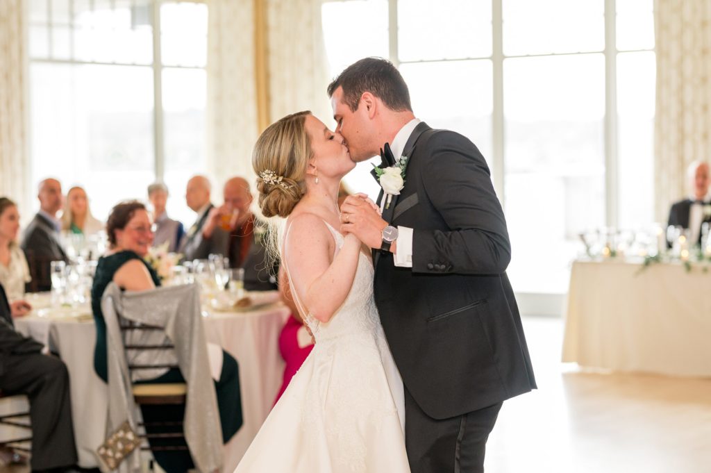 Bride and groom kissing on the dance floor during their first dance 