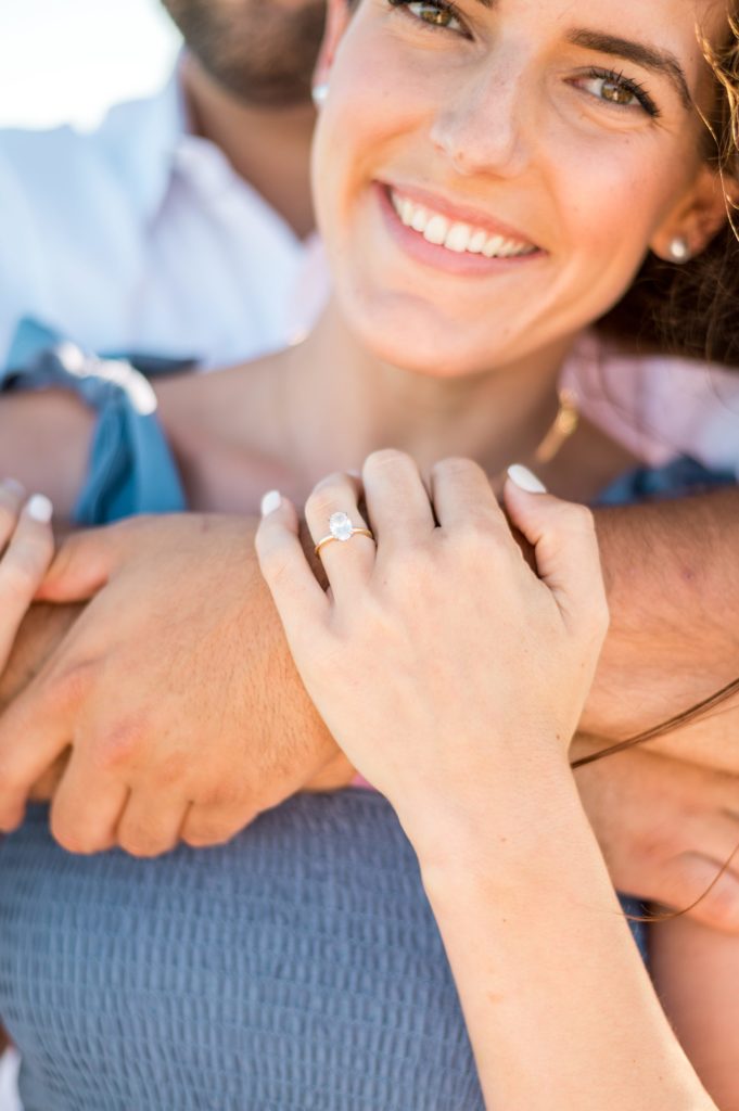 Oval engagement ring shot at Cape Cod beach engagement session