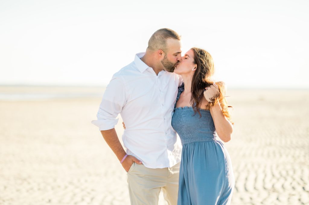 Couple kissing on at Gray's beach for engagement session