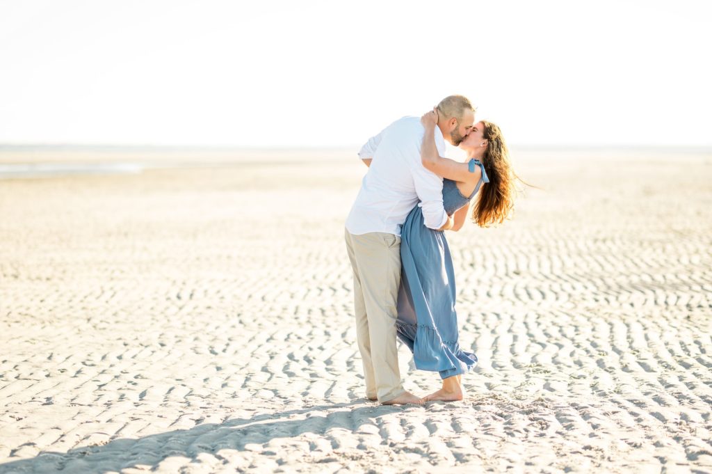 Couple kissing on at Gray's beach for engagement session