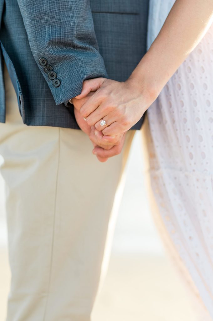 close up ring shot of couple holding hands 