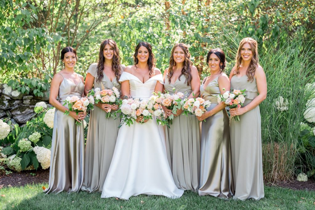 Bride and bridal party with light green satin dresses 