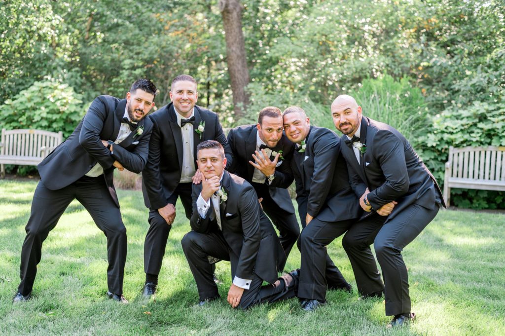 Summer outdoor wedding party portraits with groomsmen