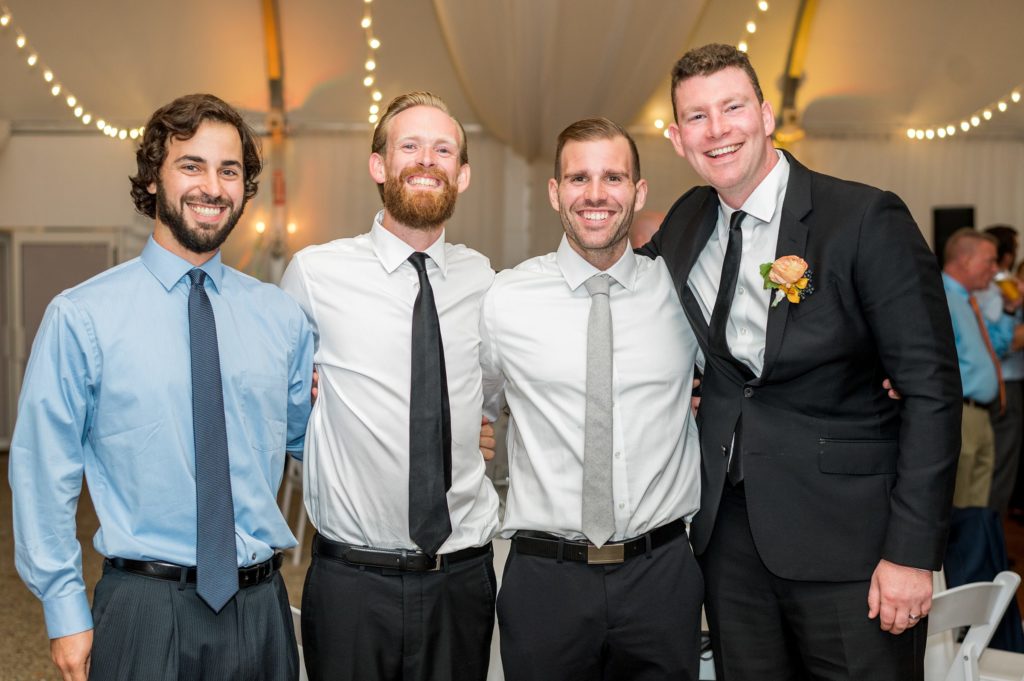 Groom and friends at wedding reception 