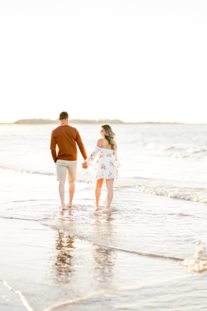 Couple walking hand in hand on wingaersheek beach 