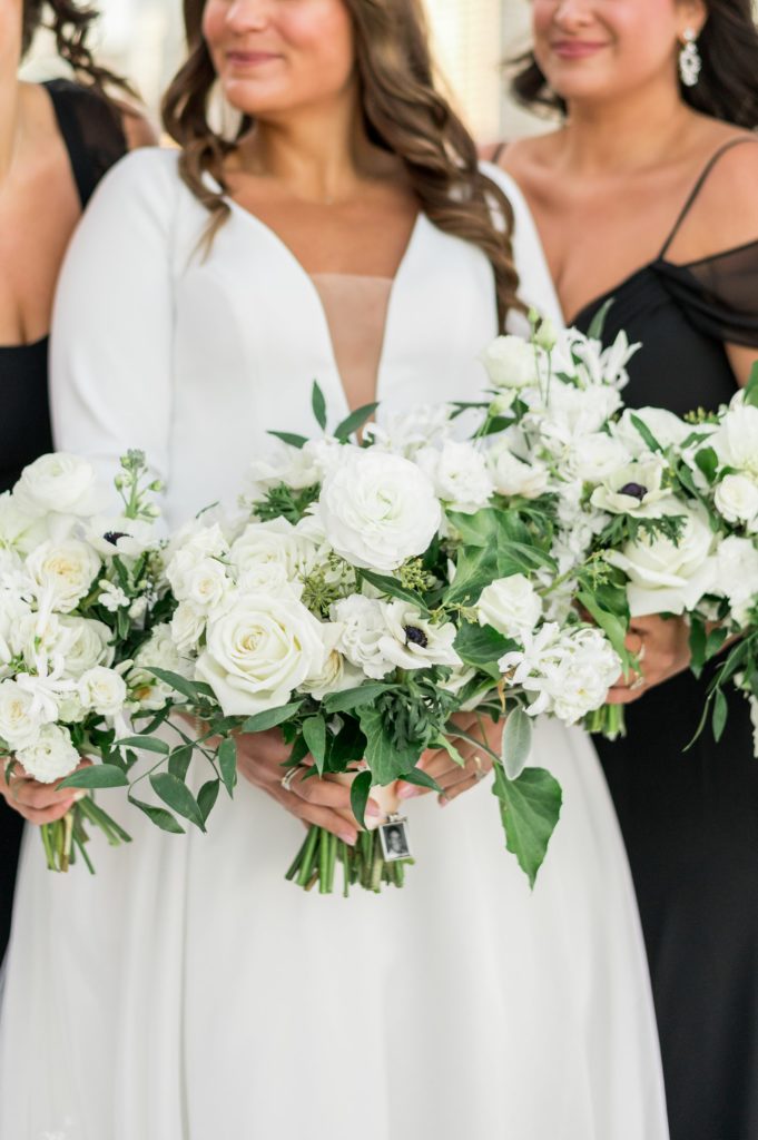 Bride and bridesmaid all white bouquets for black and white modern city wedding 