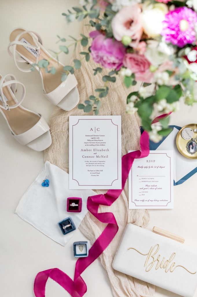 Wedding day detail photography of invitations, heels, and flowers 