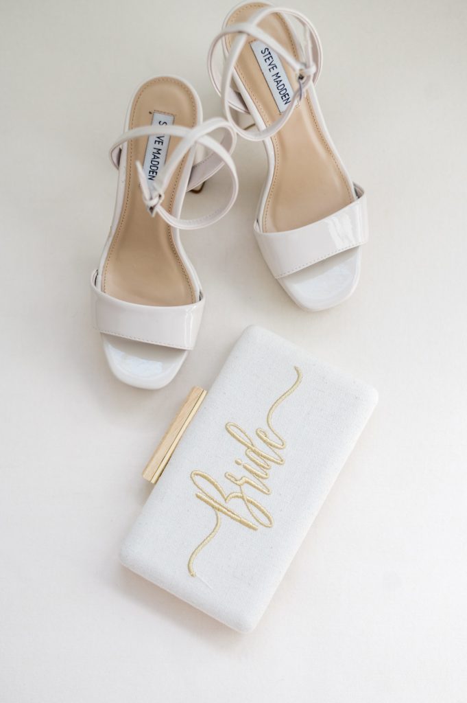 Bridal details flatlay photography of heels and bride's purse