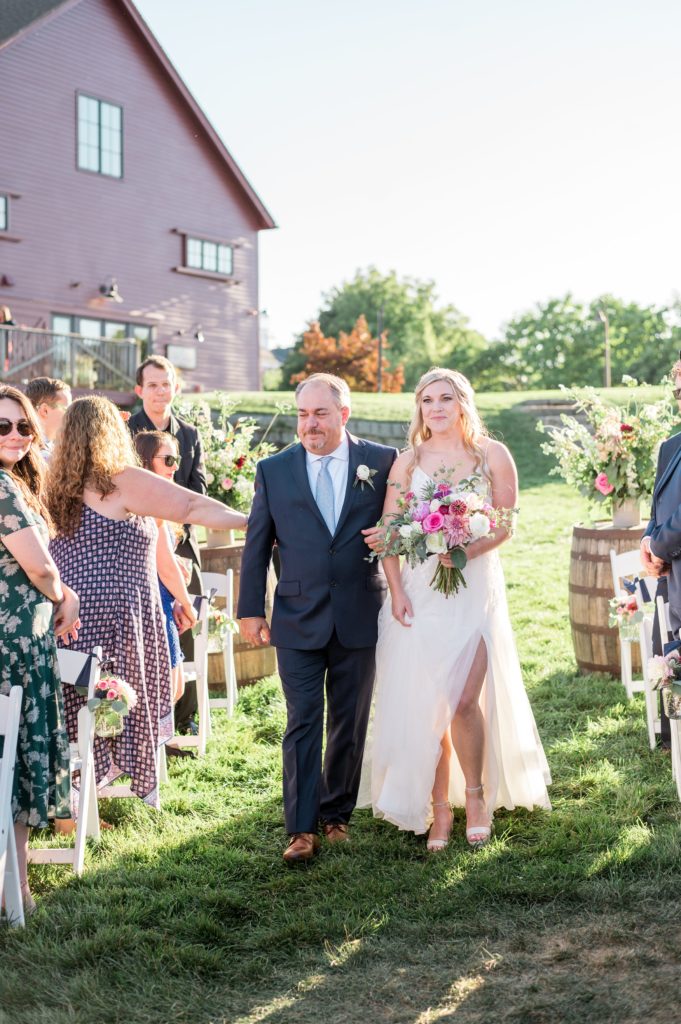 Bride walking down the aisle with her dad during outdoor ceremony at Gibbet Hill in Groton, MA