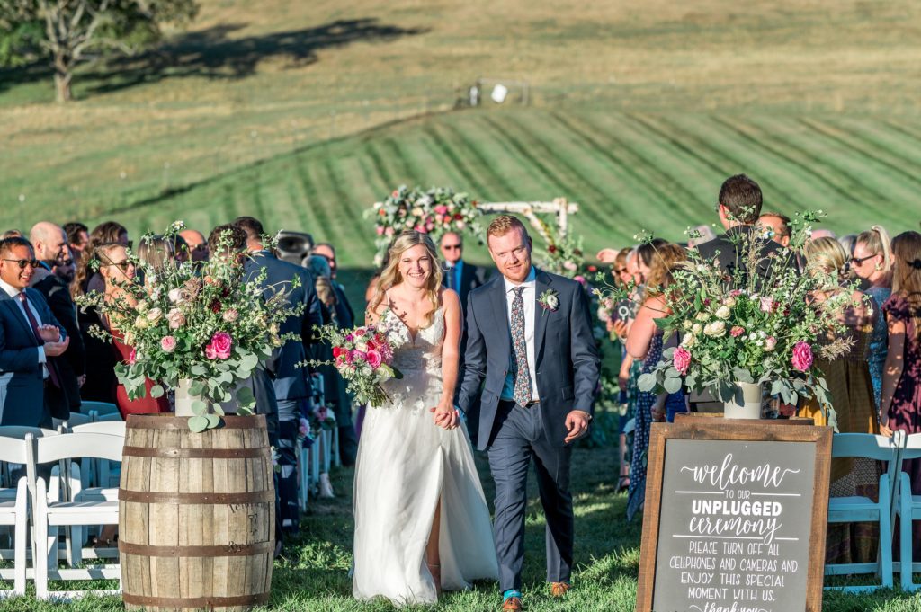 Bride and groom leaving their outdoor ceremony at Gibbet Hill in Groton, MA