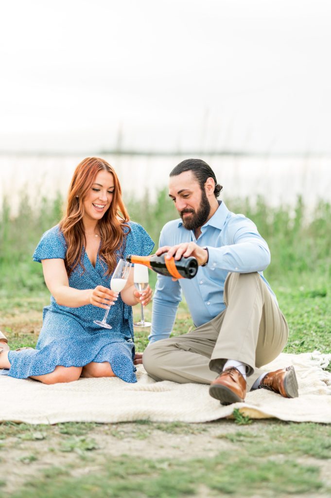 Couple drinking champagne during engagement session