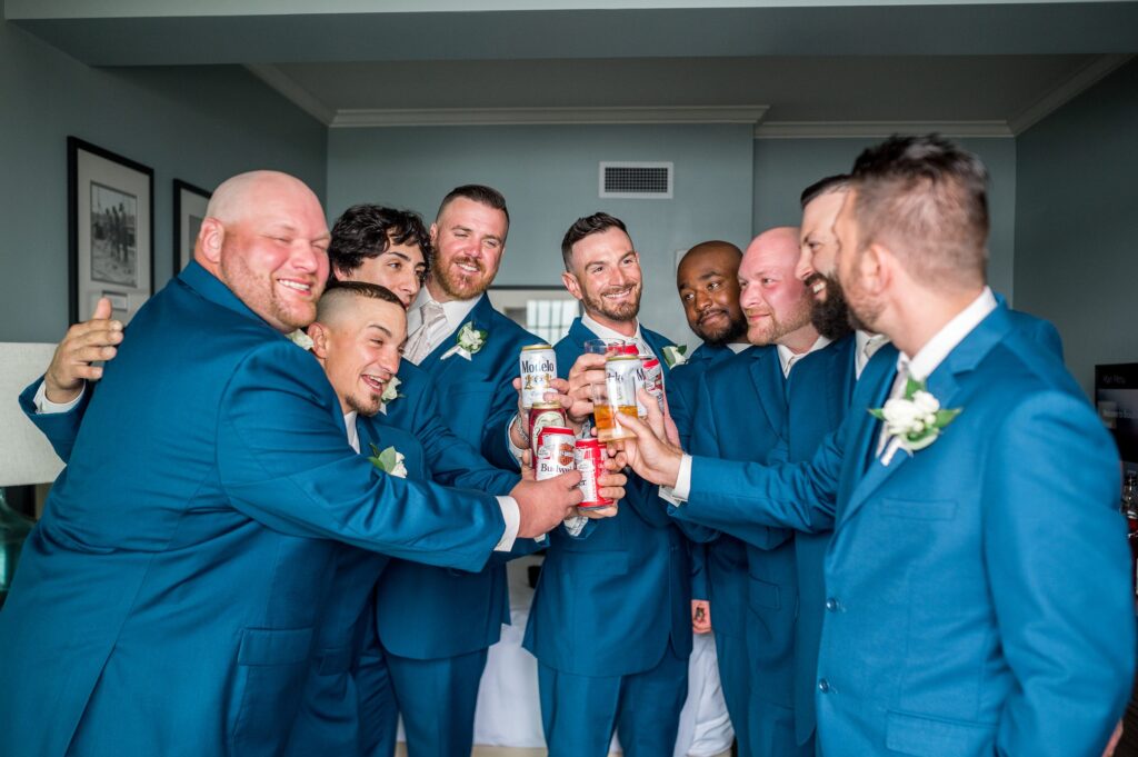 Groom and groomsmen all cheersing while getting ready