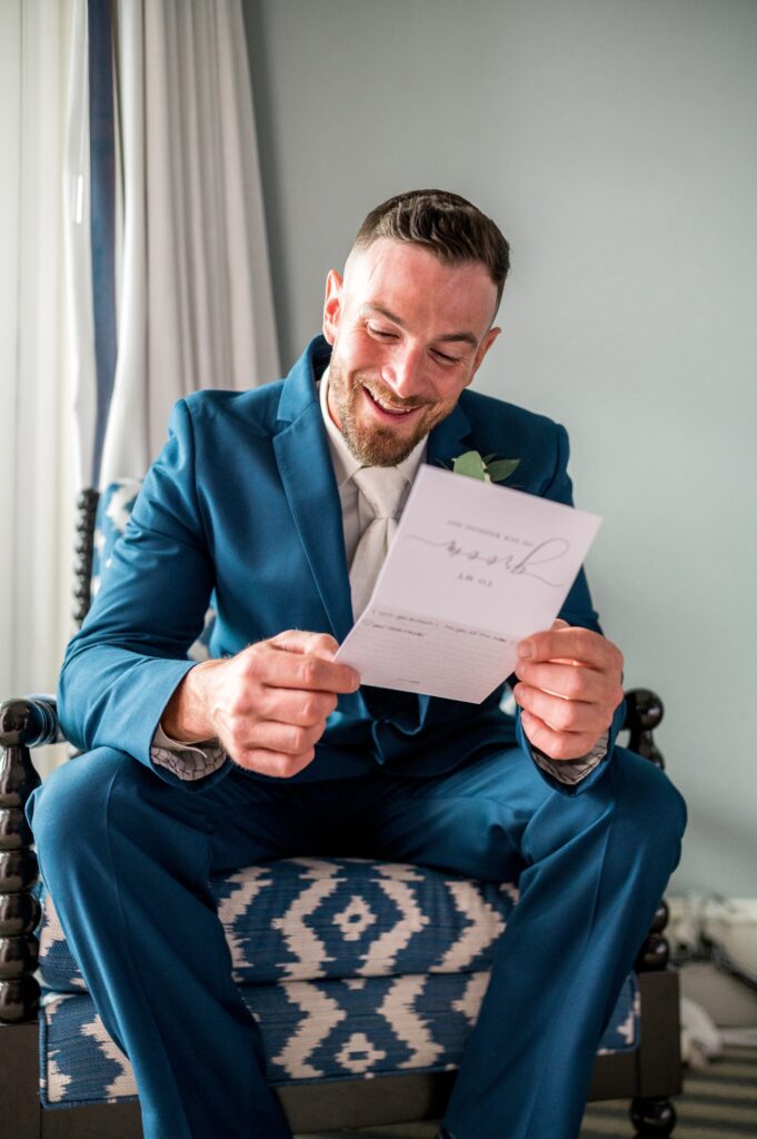 Groom reading note from bride before North Shore wedding 