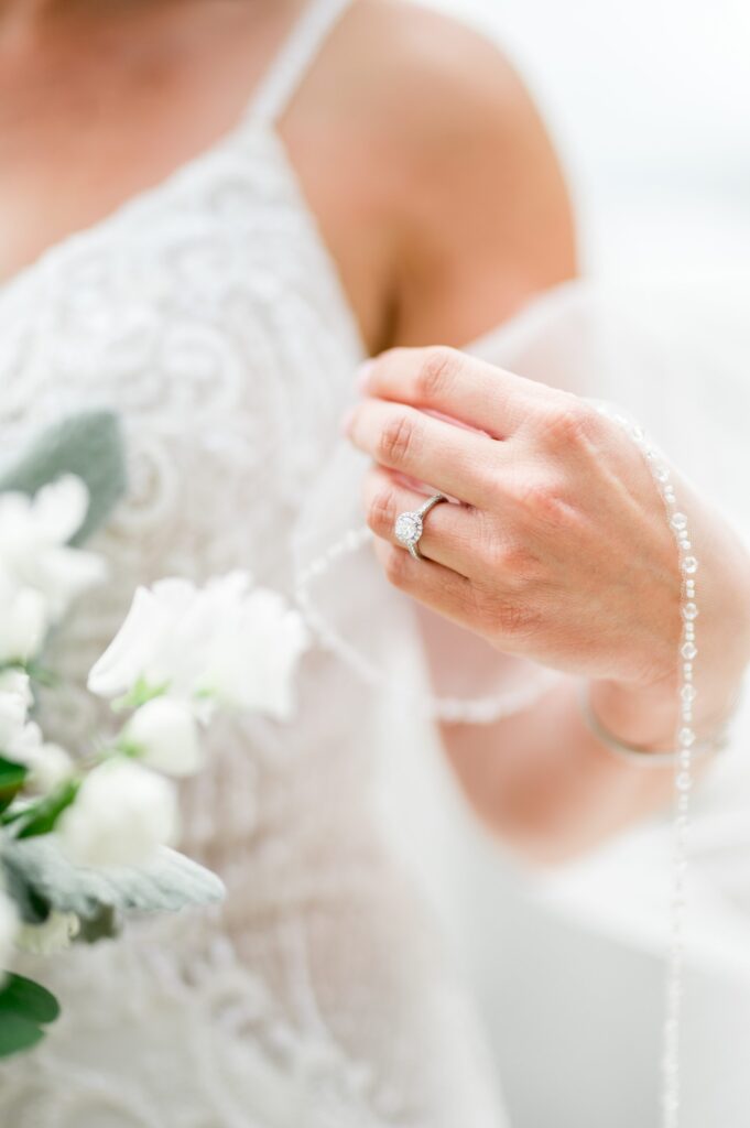 Detail photo of brides engagement ring and veil 