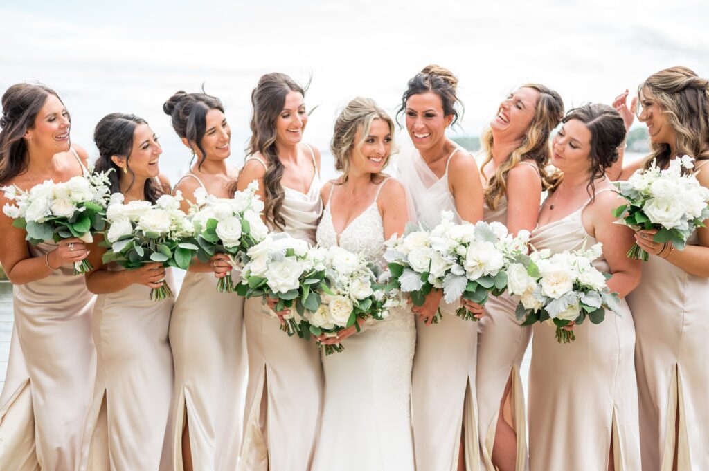 Bride and bridesmaid portrait with champagne silk dresses and all-white bouquets for North Shore wedding