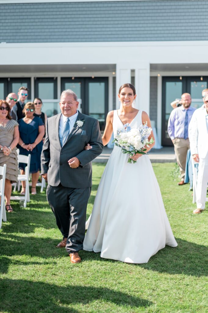 Bride and her father walking down the aisle at the Pelham House Resort