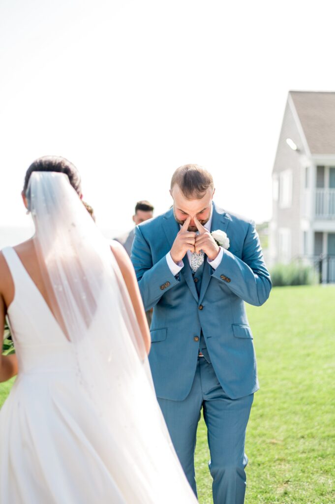 Grooms emotional reaction to seeing bride walk down the aisle at Cape Cod wedding