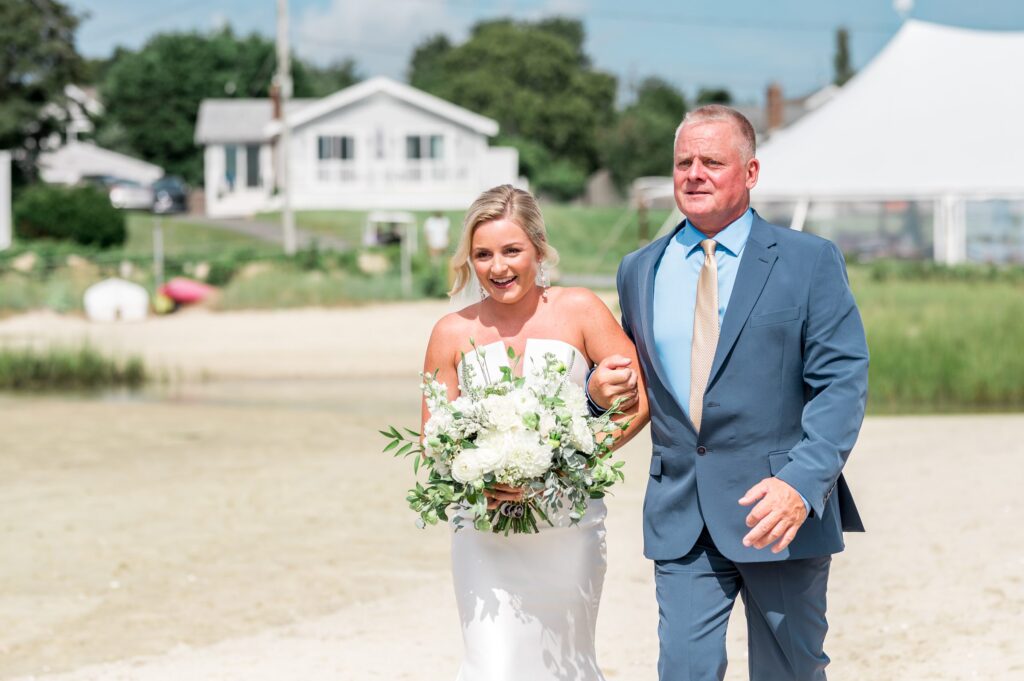Bride and dad walking down the aisle during beach wedding on Cape Cod