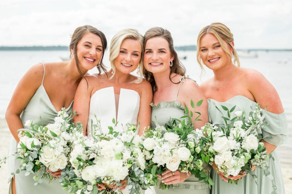 Bride and bridesmaid beach portrait with white bouquets 