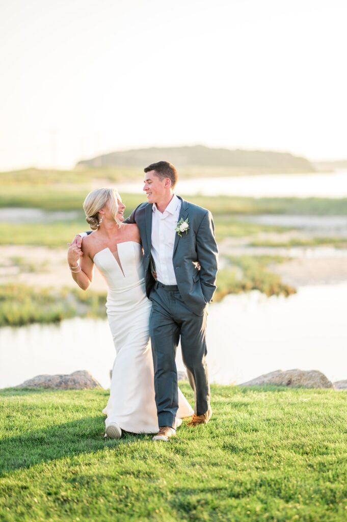 Sunset portraits of bride and groom during New England beach wedding
