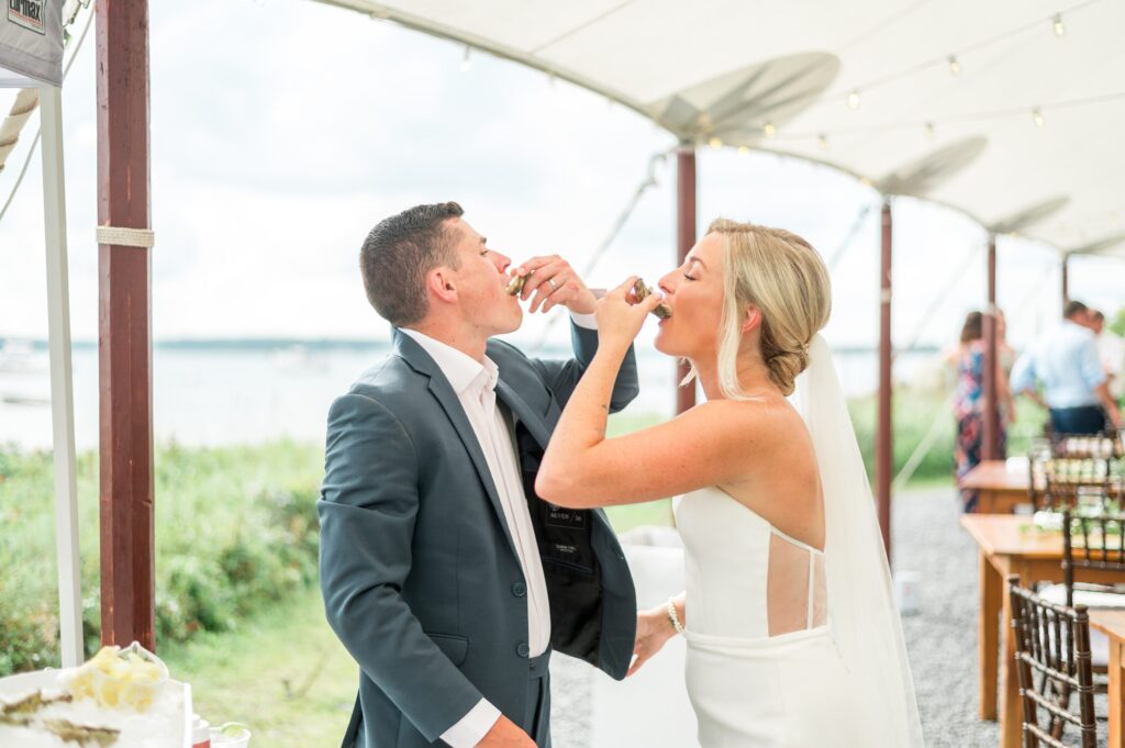 Bride and groom doing oyster shooters during wedding reception 