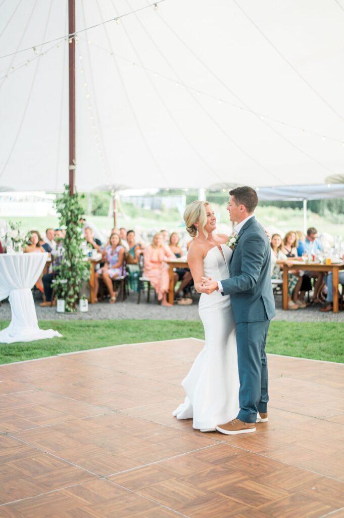 Bride and groom first dance under sail cloth tent at private home on Cape Cod