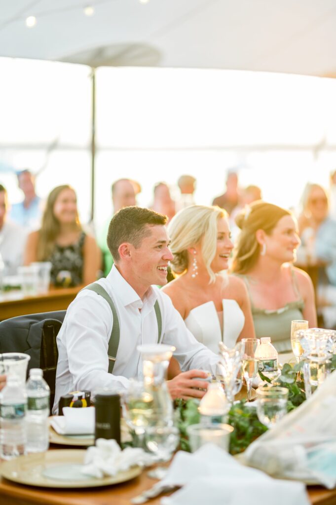 Bride and groom during tented wedding reception on Cape Cod 