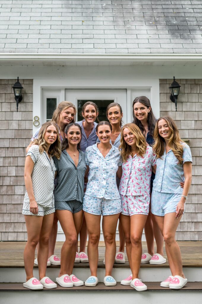 Bride and bridesmaid getting ready photo in coastal beach themed PJs and matching slippers for Martha's Vineyard Wedding