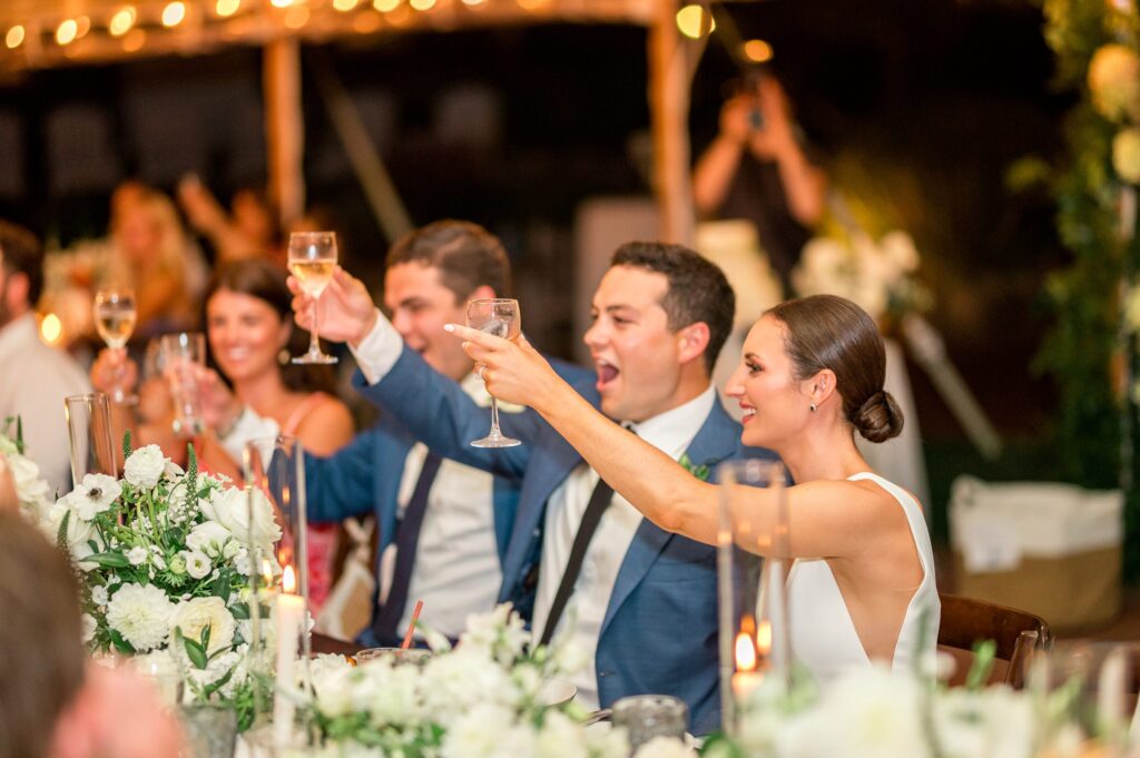 Bride and groom toast during wedding reception at Farm Neck Golf Club Martha's Vineyard Wedding