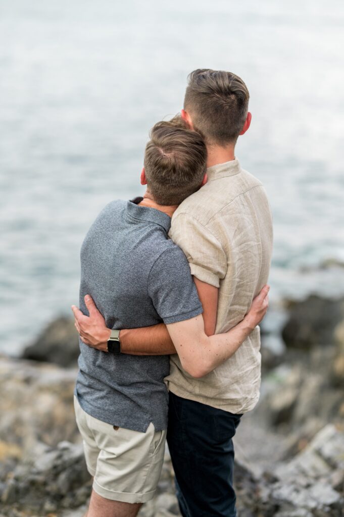 Couple hugging and looking at the ocean 