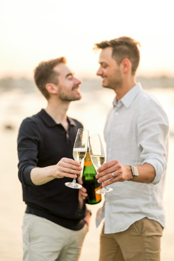 Couple drinking champagne during engagement photos 
