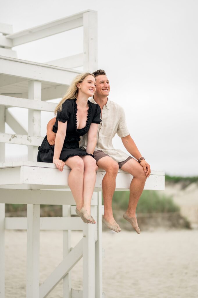 Couple sitting on the lifeguard stand