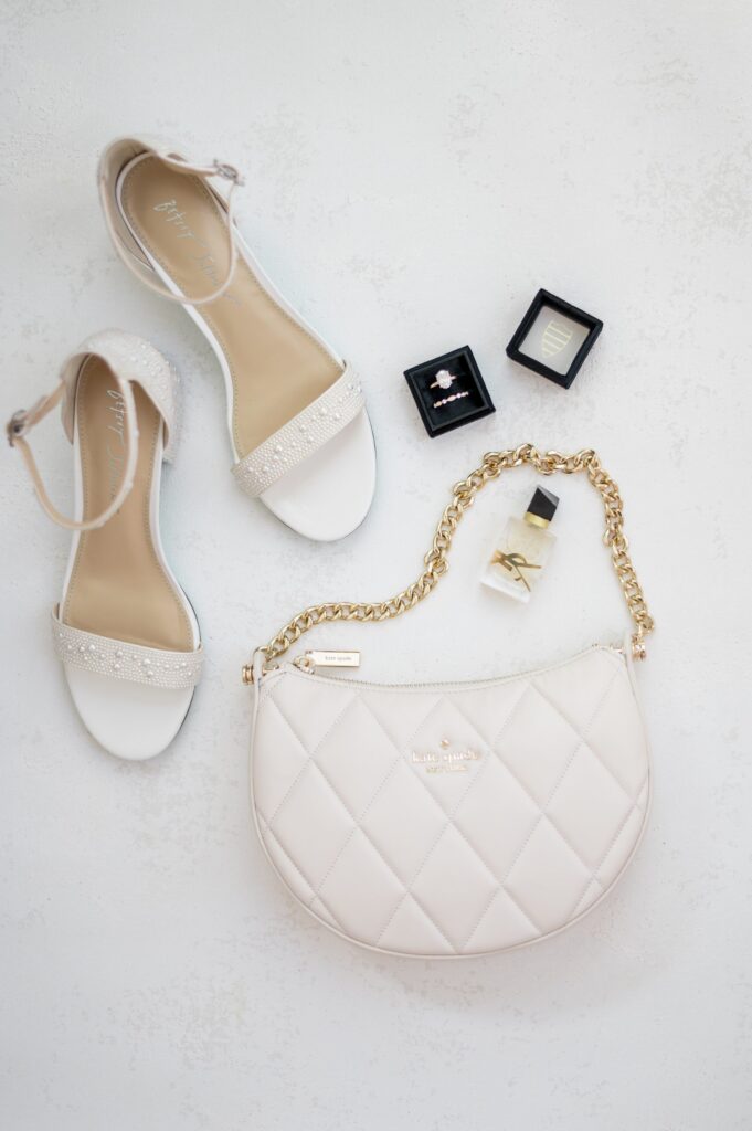 Flat Lay Detail Photography with bride's pearl heels, jewelry, perfume and rings 