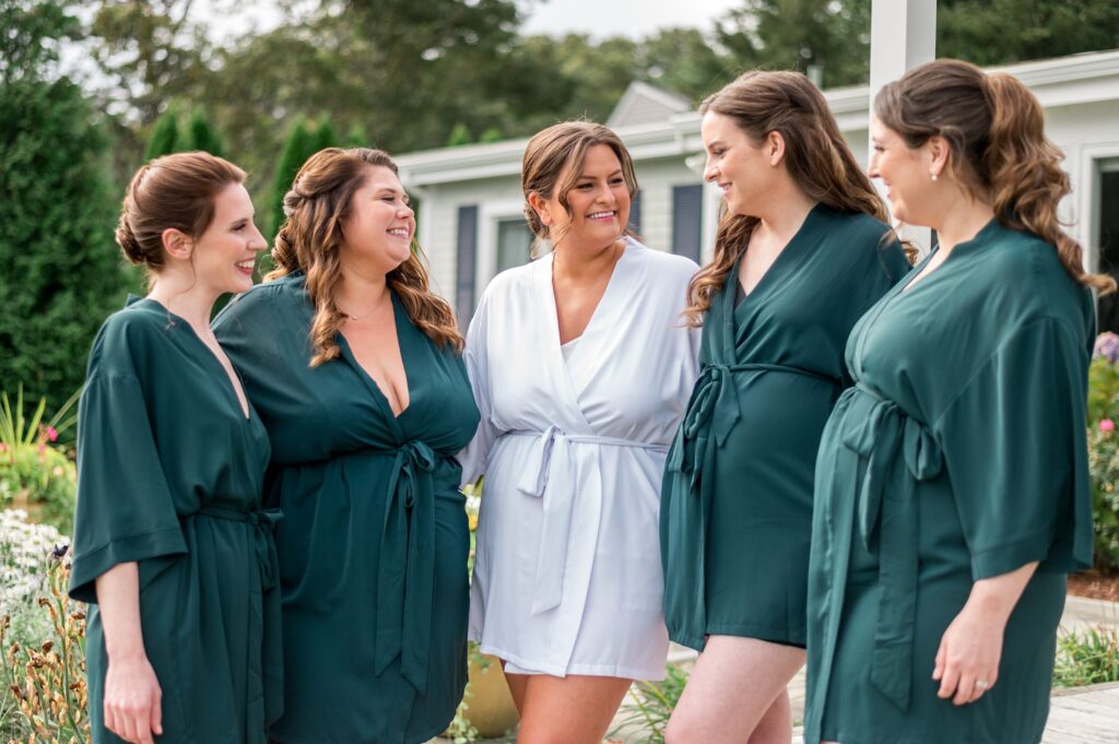 Bride and bridesmaids getting ready at an Airbnb in Mashpee, MA wearing matching robes