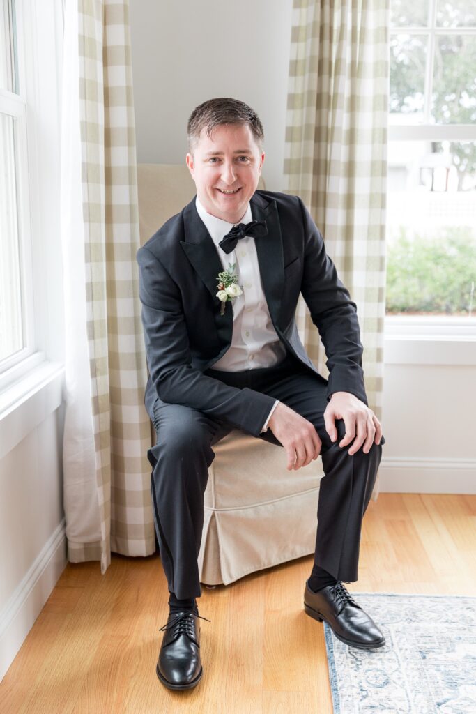 Groom portrait wearing a tux during getting ready portraits before New England beach wedding