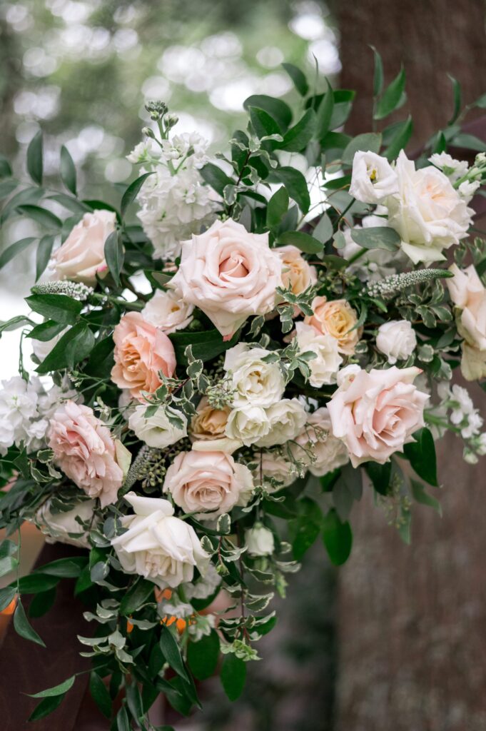 Light pink and orange flowers for ceremony arbor 