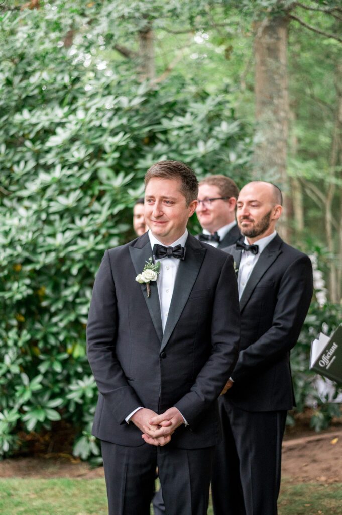 Groom's reaction to seeing bride walk down the aisle during Cape Cod backyard wedding