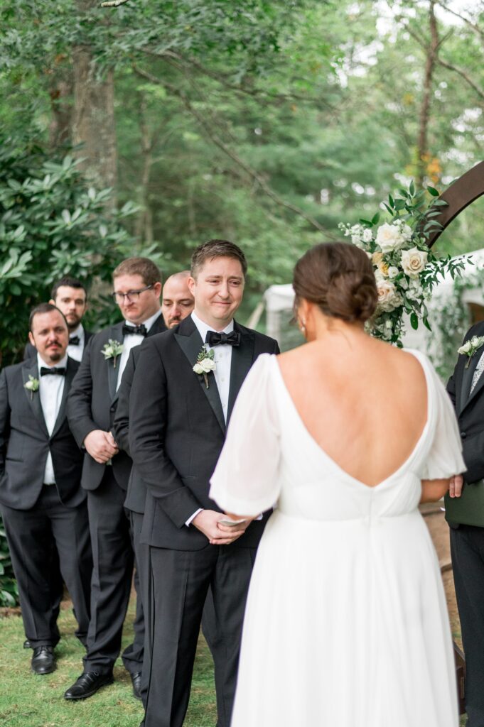 Bride and groom sharing personal vows during outdoor New England wedding ceremony 