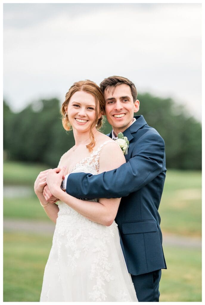 The bride and groom embrace on at Indian Pond Country Club.