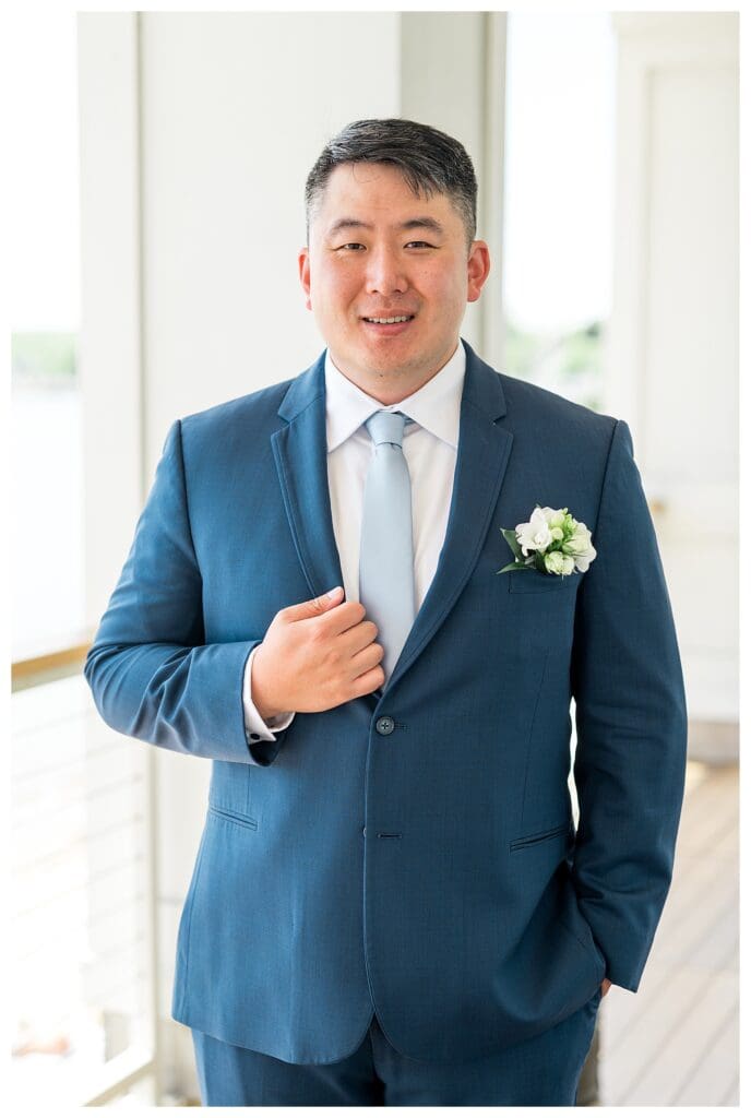 Groom posing before the first look before his coastal wedding ceremony.