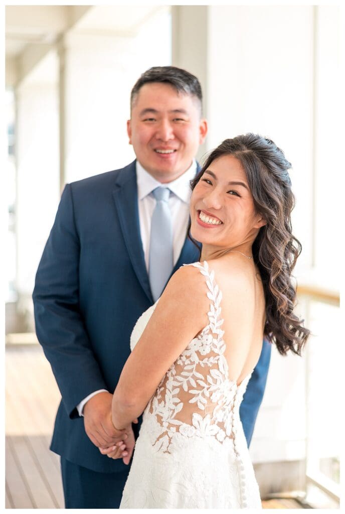Groom beaming at the bride during a first look filled with natural light and emotion.