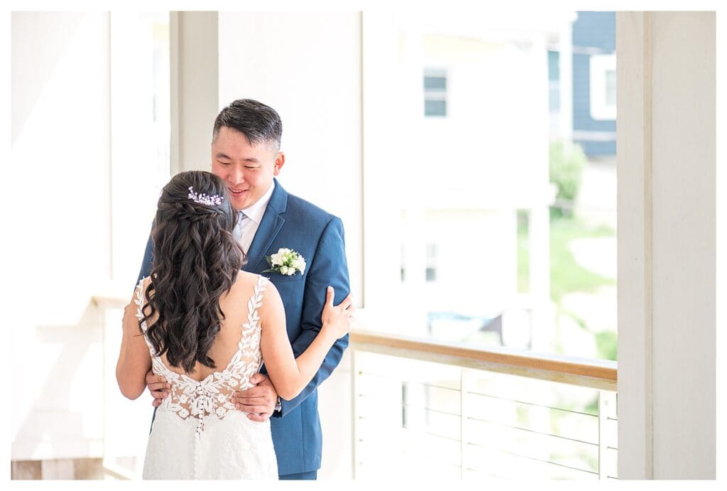 Bride and groom sharing a quiet moment on the porch before their coastal wedding ceremony.