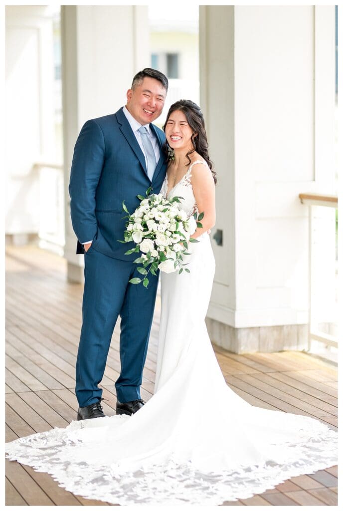 Beauport Wedding Photography: Bride and groom standing together with white florals at a Massachusetts seaside wedding venue.