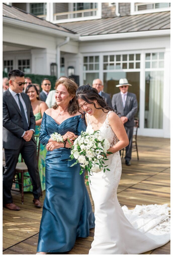 Bride walking down the aisle at a coastal Massachusetts wedding ceremony at The Beauport Hotel.