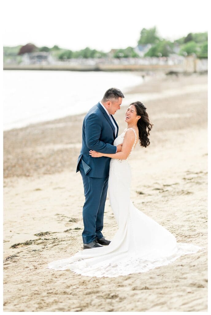 Beauport Wedding Photography: Bride and groom sharing laughter during golden hour portraits by the ocean.