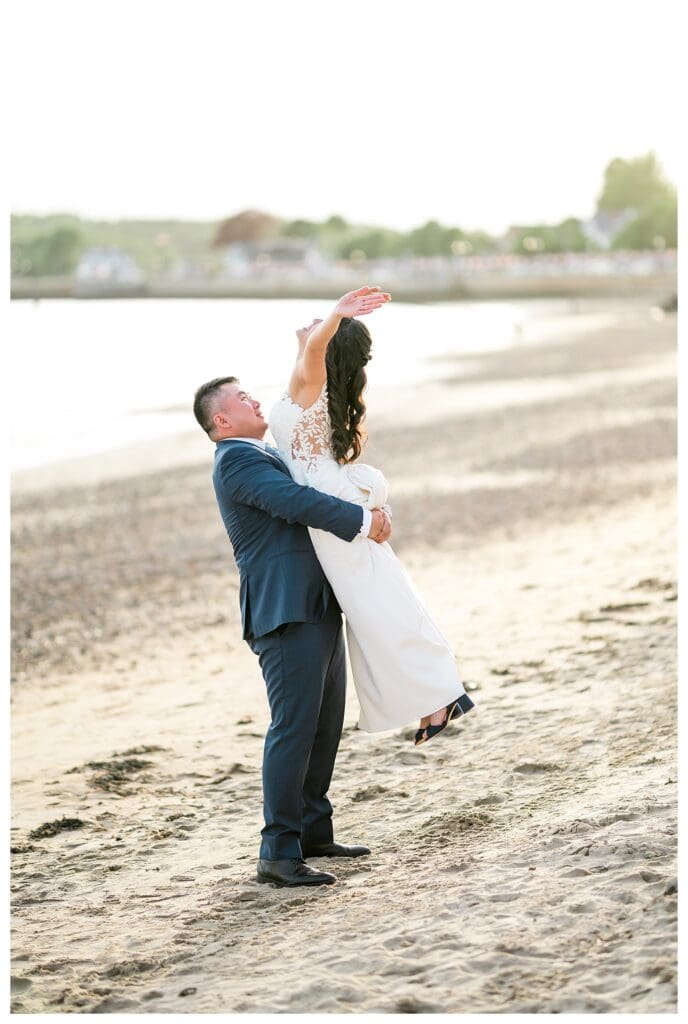 Bride & Groom doing the Dirty Dancing Lift against the backdrop of The Beauport Hotel's beach.