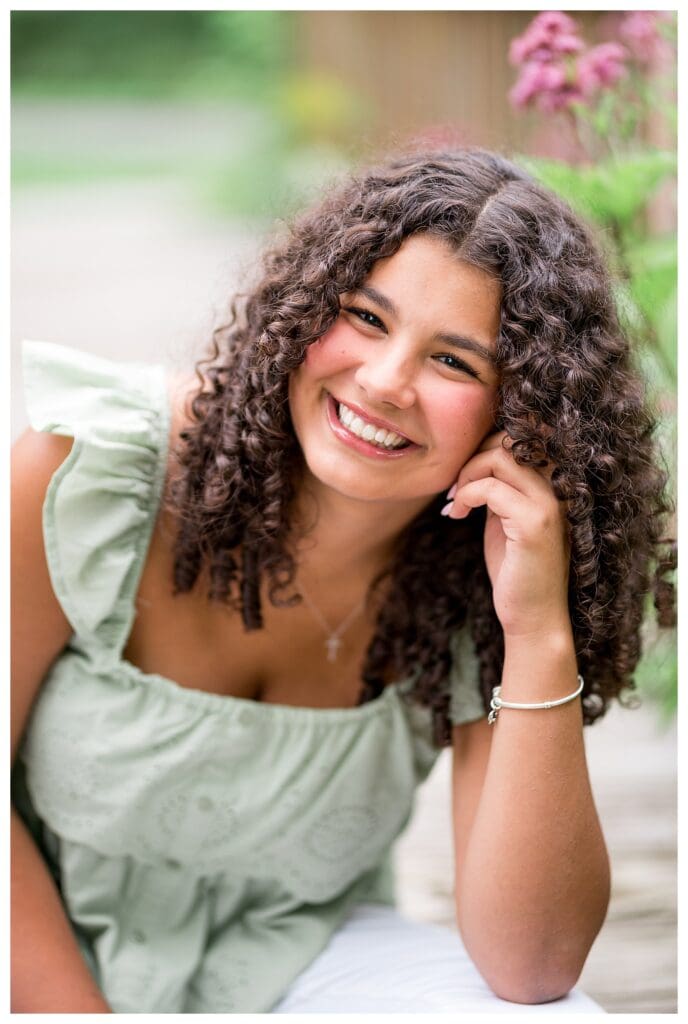 Close-up of Aubrie’s curly hair framing her face as she smiles at the camera.