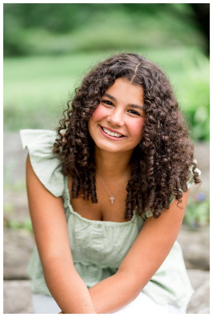 Smiling senior portrait at the Acton Arboretum.